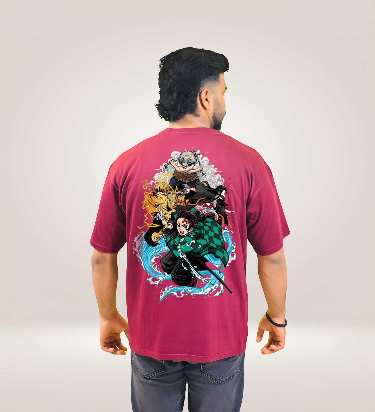 Back view of maroon oversized T-shirt with Demon Slayer character design, worn by man.