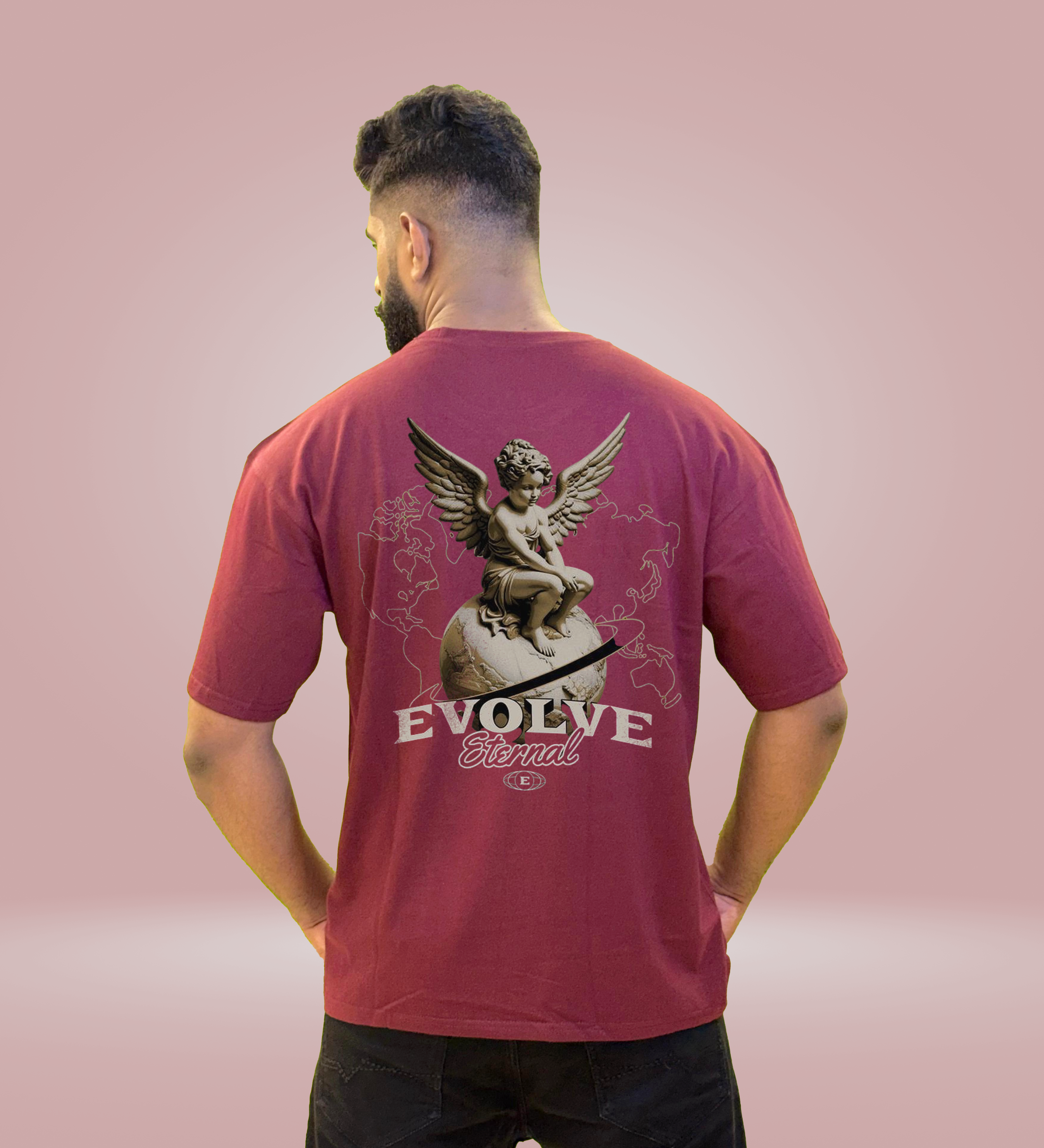 Maroon oversized Evolve Eternal T-shirt with angel design on back, worn by man facing away.