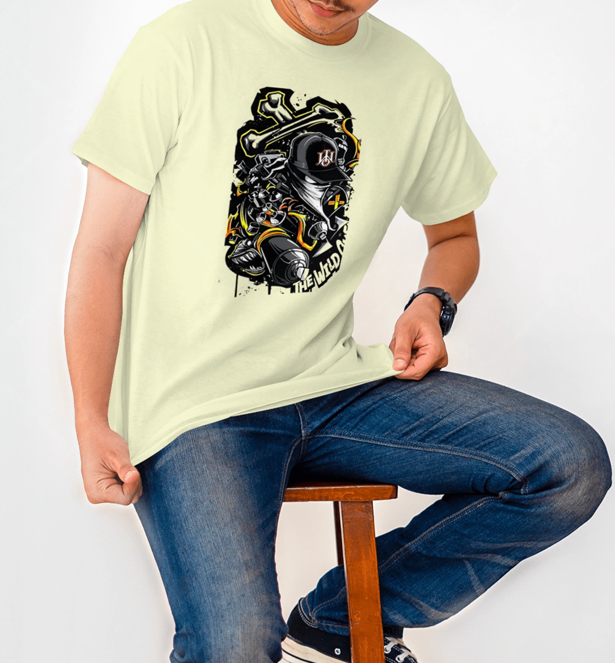 Model wearing AAMS Ninja Cream Graphic T-Shirt with ninja biker design and 'The Wild' typography