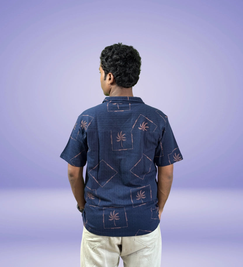 Back-side view showcasing palm-inspired patch pattern on navy shirt