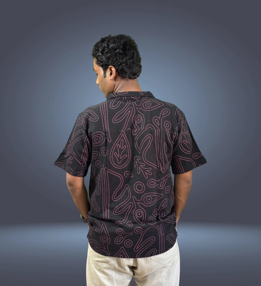 Back view of black shirt showing full abstract line pattern