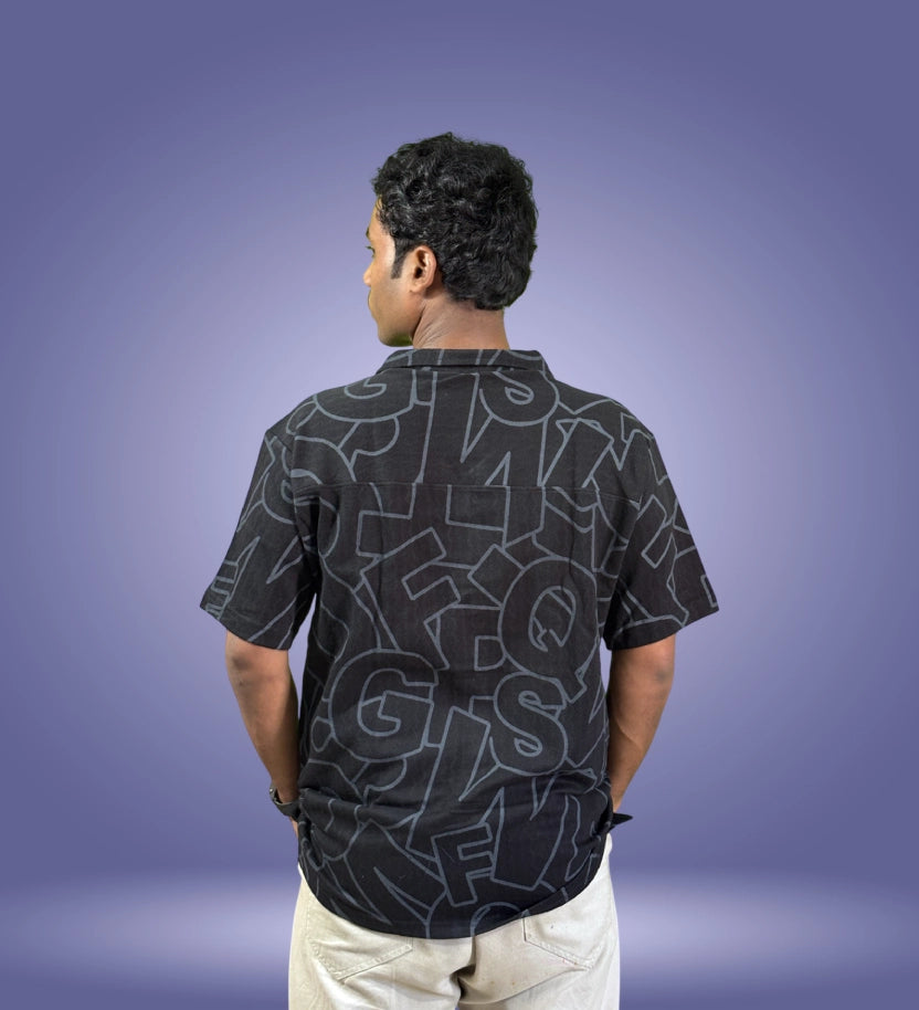 Back view of black typographic pattern shirt showing full print