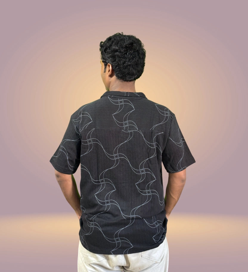 Back view showing full abstract flowing line pattern on shirt
