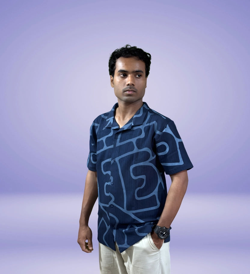 Front-side angle showcasing navy abstract design shirt