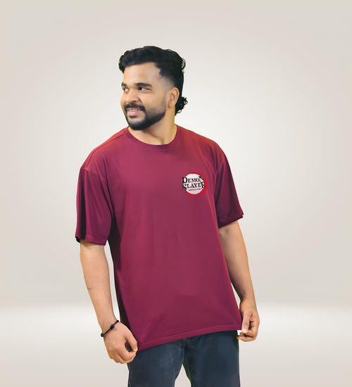Maroon oversized Demon Slayer T-shirt with front logo, worn by smiling man.