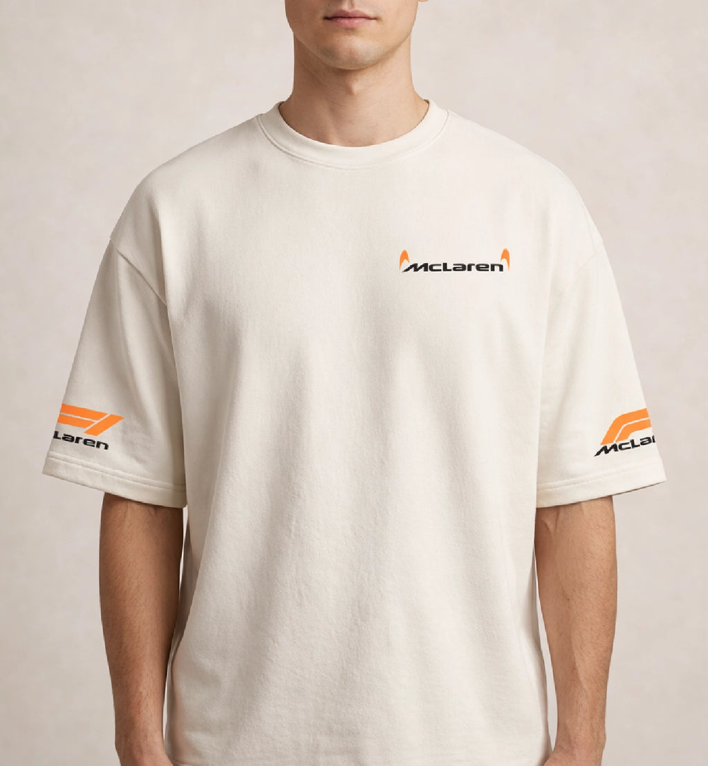 Men wearing cream McLaren oversized t-shirt with minimal chest logo and sleeve branding