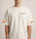 Men wearing cream McLaren oversized t-shirt with minimal chest logo and sleeve branding