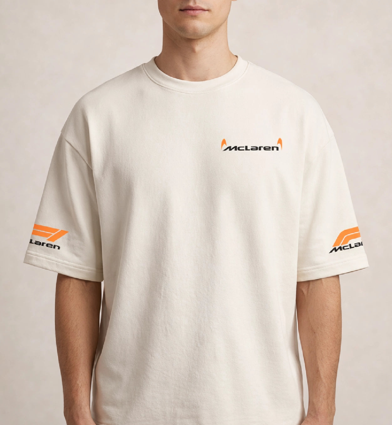 Men wearing cream McLaren oversized t-shirt with minimal chest logo and sleeve branding
