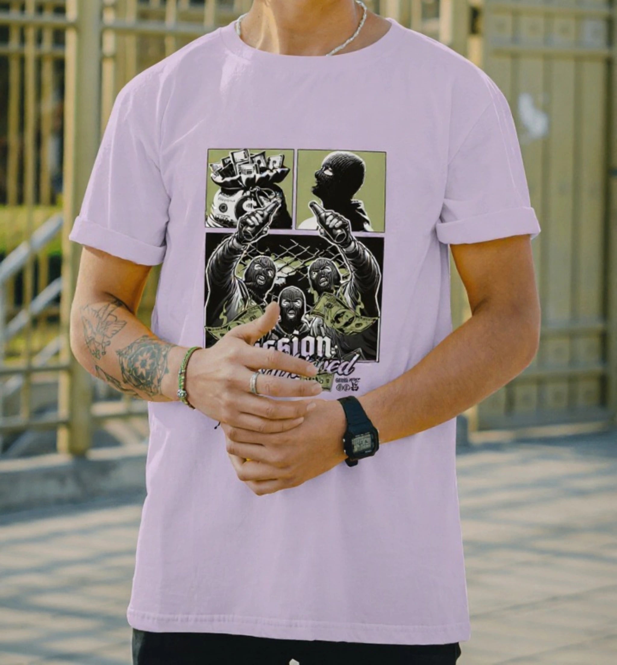 Model wearing AAMS Mission Successful Lavender Graphic T-Shirt with masked figures and cash comic design