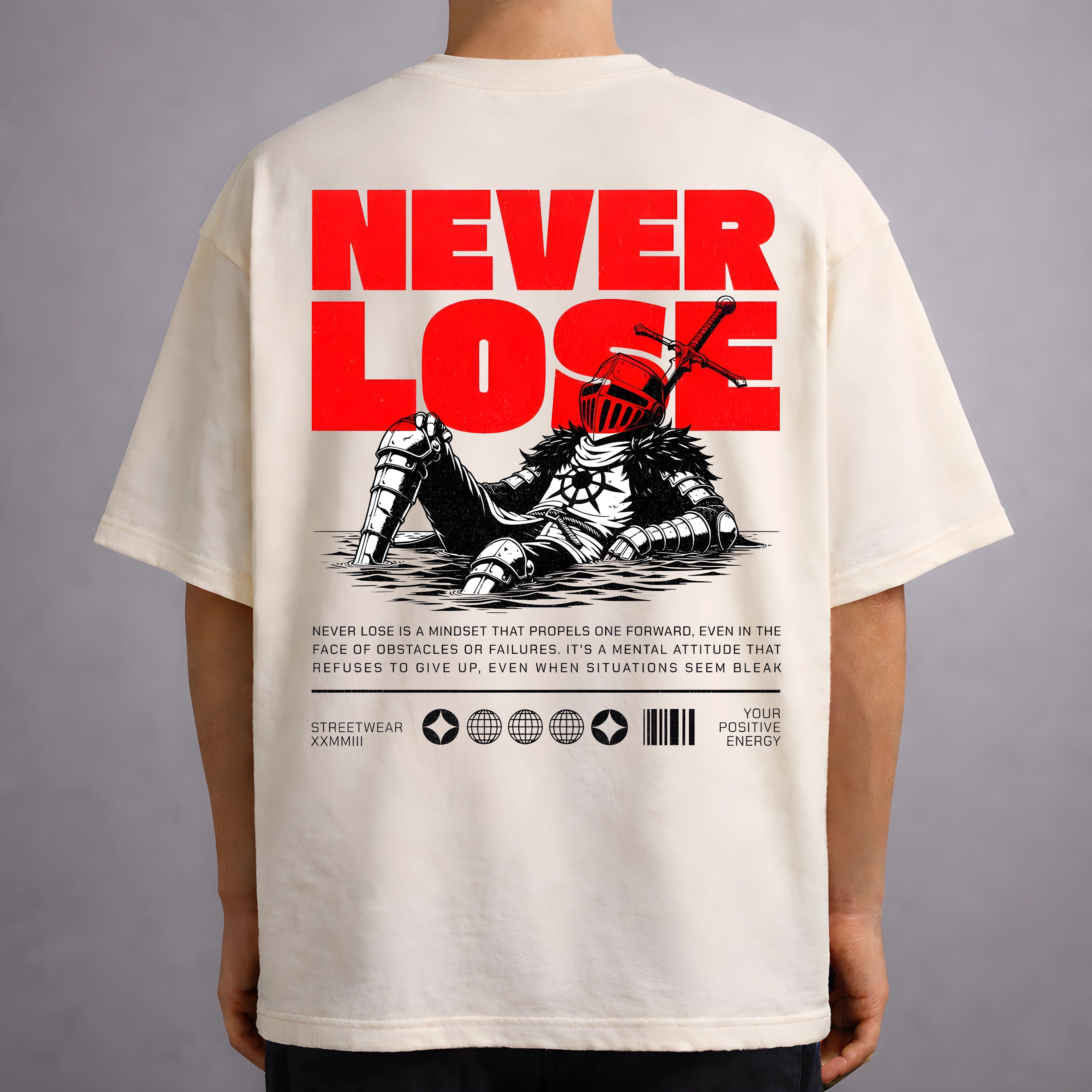 Cream oversized T-shirt featuring a large red “NEVER LOSE” graphic on the back with an illustration of a medieval armored knight sitting with a sword, along with motivational text and streetwear-style graphic elements below.