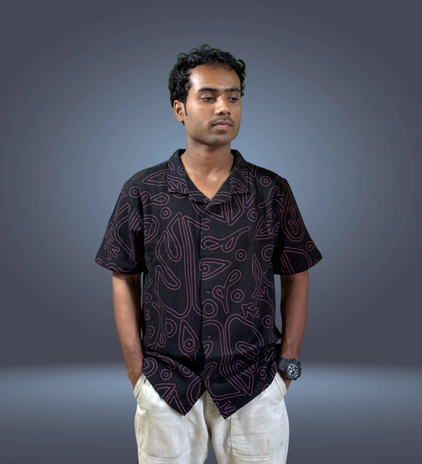 Side-front angle of black abstract print shirt with relaxed fit