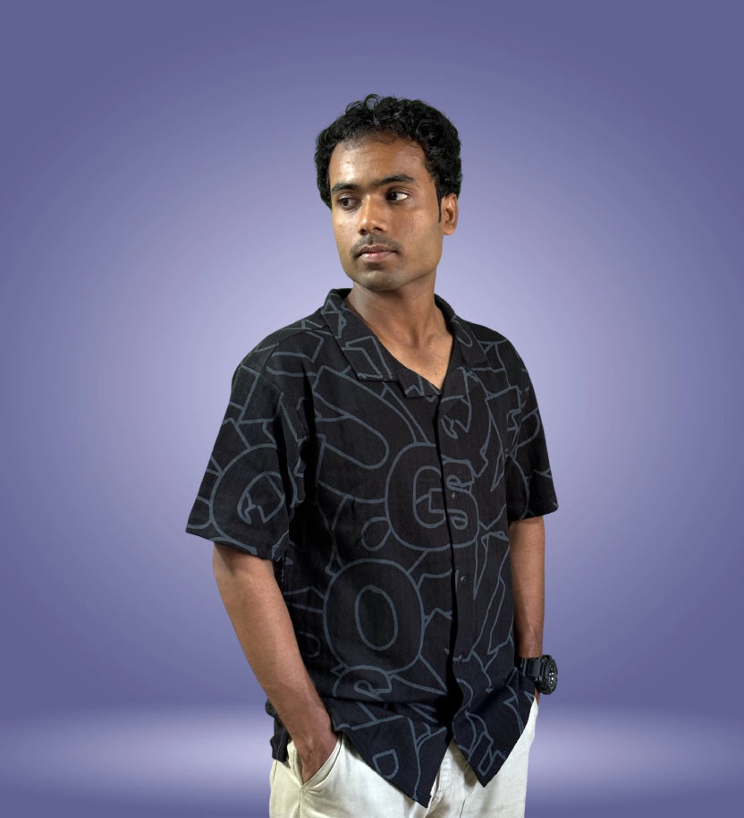 Side-front angle of black typographic shirt with relaxed fit