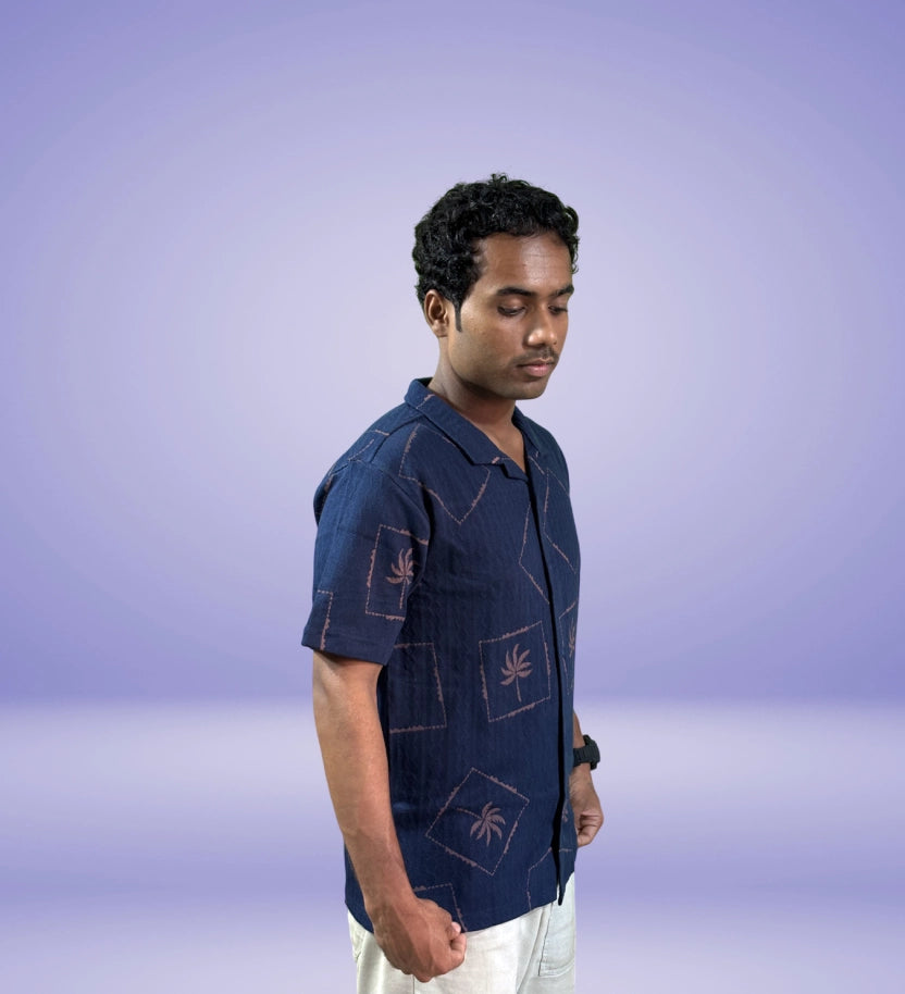 Side angle view of navy tropical print relaxed shirt