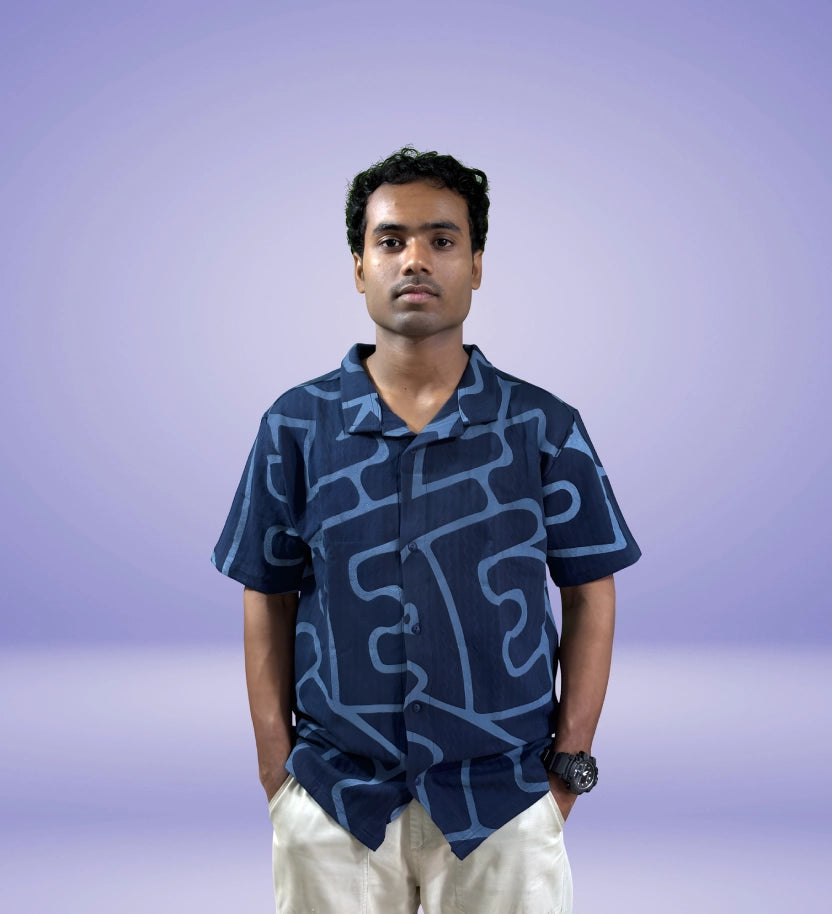 Straight front view of navy bold pattern shirt with model standing