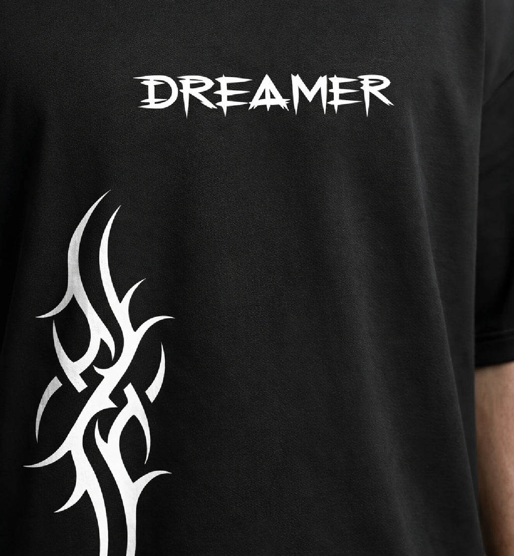 Dreamer text graphic on black oversized t-shirt with edgy abstract pattern streetwear style